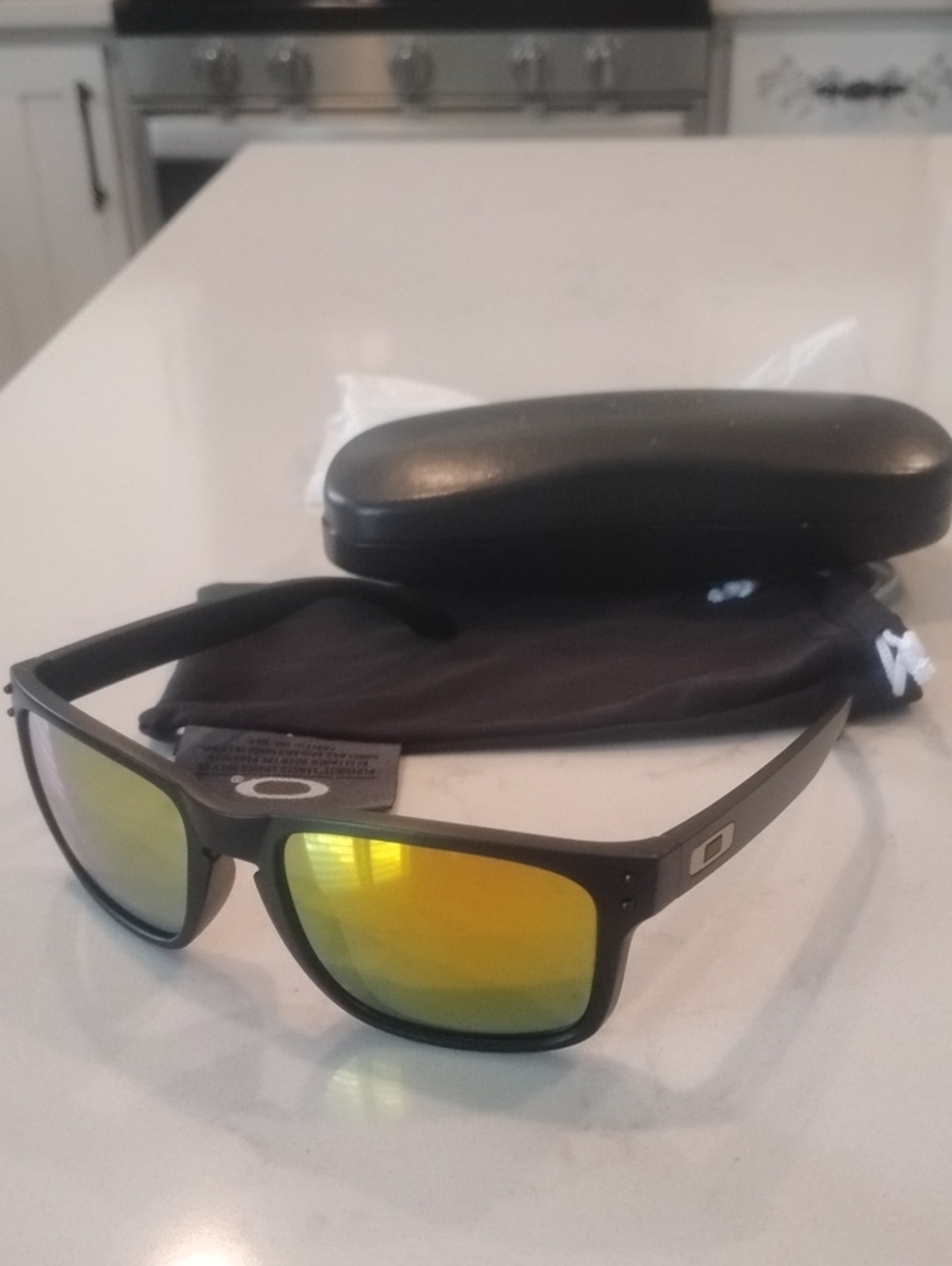 Oakley Matte Black Sunglasses with Yellow-Orange Mirror Lenses